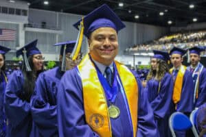Graduate in cap and gown at Florida State Fairgrounds.