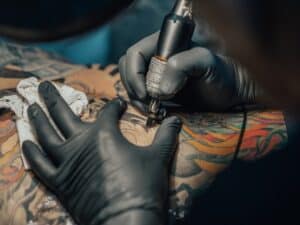 Tattoo artist working on colorful tattoo at Florid.