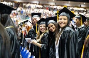 Graduates celebrating at Saint Leo University commencement ceremony.