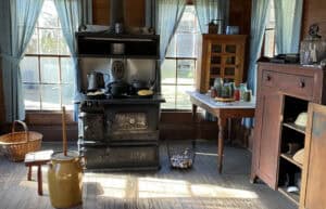 Vintage kitchen scene with stove and rustic decor.