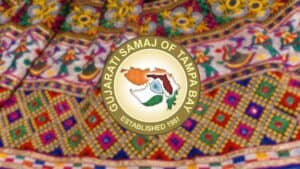 Gujarat Samaj of Tampa Bay logo on colorful fabric.