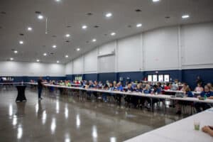 People dining at tables inside Florida State Fair.